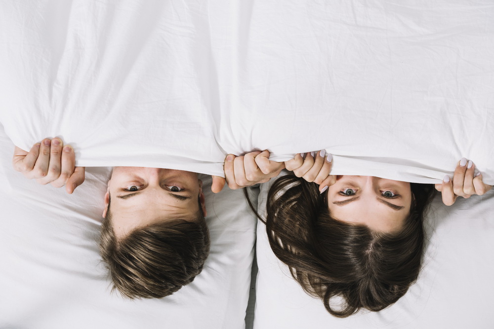 Couple under Bed Sheets - Cancer Man and Capricorn Woman in Bed