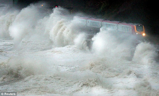 Battered: The winter storms destroyed many businesses and the railway line in Dawlish, Devon (pictured)