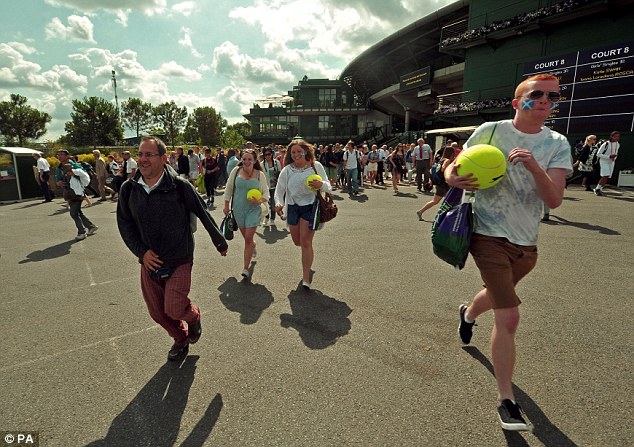 Full swing: Crowds arrive at Wimbledon yesterday. It feels like the start of summer, but could it soon be over?