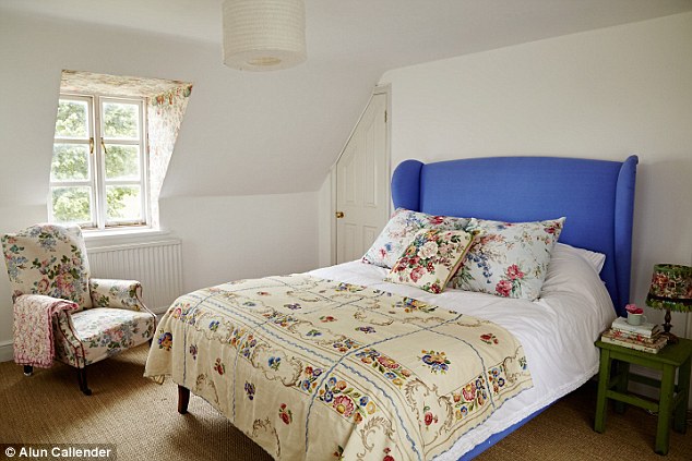 RIGHT AND FAR RIGHT In Sarah and Pete’s bedroom, vintage curtains, eiderdowns and an heirloom embroidered bedcover showcase Sarah’s obsession with antique fabrics. ‘I can’t resist a bit of chintz,’ she says. A shelf is edged with a piece of vintage wallpaper for a further layer of decoration.