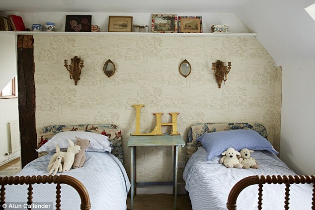 The children’s room has a cottage-inthe- woods feel, with twin beds from Stable Antiques in Storrington (stableantiques.co.uk). The headboards are reupholstered in Sanderson fabric (sanderson-uk.com). The big letters were from Ardingly antiques fair (iacf.co.uk). West Elm (westelm.co.uk) sells similar tickingstripe bedlinen
